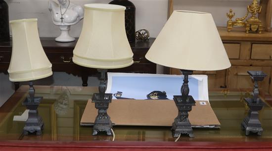 A pair of Chinese pewter altar sticks and two others similar mounted as lamps